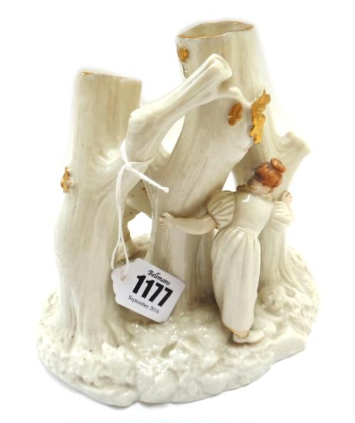 A Royal Worcester centrepiece spill vase, late 19th century, after a design by Hadley, modelled with children playing amongst tree trunks, painted and