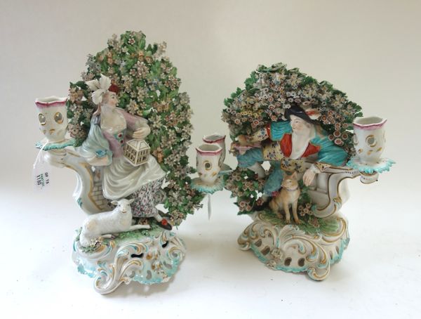 A pair of Derby porcelain two branch figural candlesticks representing Liberty and Matrimony, circa 1770, modelled as a shepherd and shepherdess with