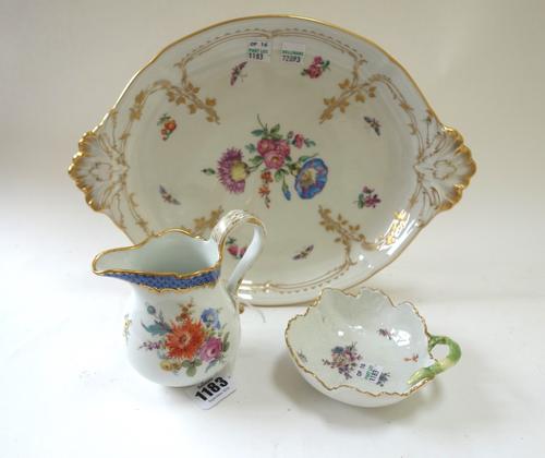 A Meissen porcelain jug, 20th century, decorated with flowers, 11.5cm high, together with a Meissen leaf shaped dish, 11.7cm diameter, and a Berlin po
