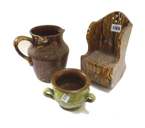 A group of agate and slipware pottery, 19th/20th century, comprising; a Ewenny green glazed and inscribed tyg signed Jones Bridgend, 8.5cm. high; a Ha