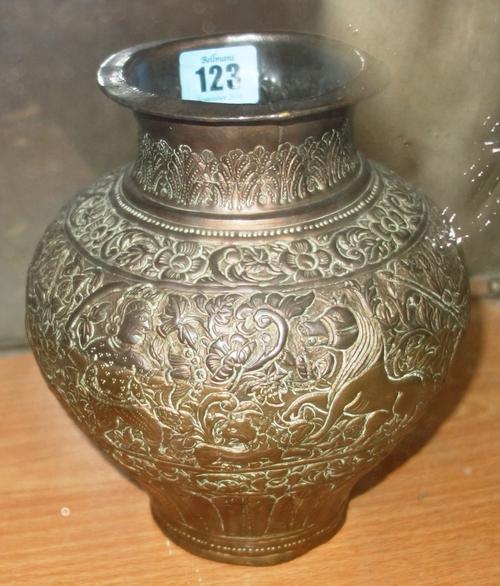 An Indian embossed copper vase, probably 19th century, of baluster form, decorated in relief with a frieze of hunters and animals against foliage, 19c
