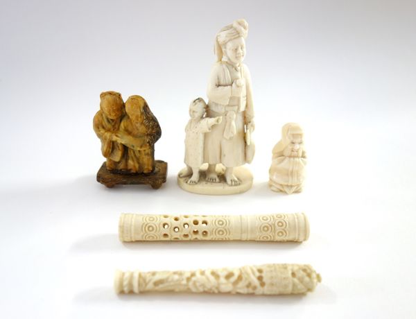A small Indian ivory carving of a man and child, late 19th/early 20th century, standing on an oval base, 9.5cm.high; also a small horn carving of two