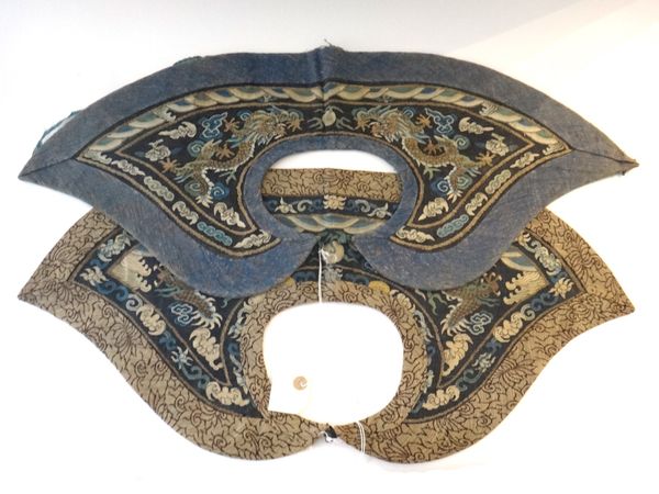 Two Chinese blue-ground kesi dragon collars, late 19th century, each worked with two confronting dragons chasing a flaming pearl amongst cloud scrolls