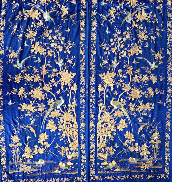 A good pair of Chinese embroidered silk curtains and a pair of side panels, early 20th century, each curtain finely embroidered in coloured threads an