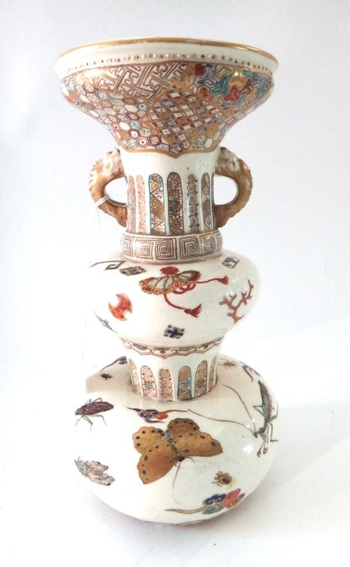 A Japanese satsuma two-handled vase, Meiji period, of baluster form set with small dolphin handles, painted with insects, scrolls and a frog, 25.5cm.