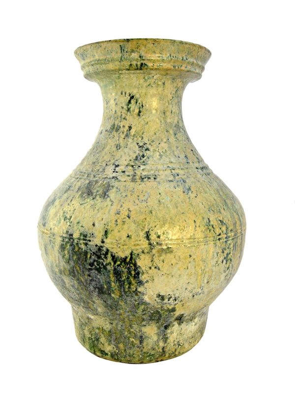 A large Chinese green glazed pottery wine jar, Hu, Han Dynasty, of baluster form with horizontal ribbing, 45.5cm. high. Illustrated