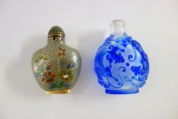 A Chinese blue overlay glass snuff bottle, 20th century, decorated with dragons and bats, 6cm. high; and a plique a jour floral decorated snuff bottle