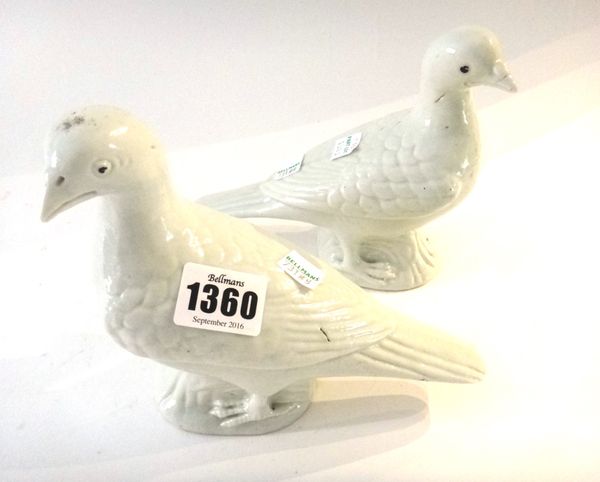 A pair of Chinese porcelain white glazed  pigeons, 19th century, facing to the left or right, the eyes picked out in black enamel, 14cm high, (2).