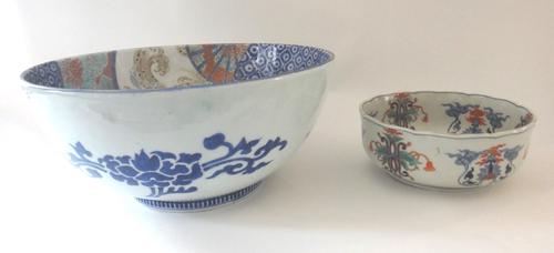 A large Japanese Fukagawa porcelain deep bowl, Meiji period, the interior painted with panels of deer in a landscape and tortoise, against an elaborat