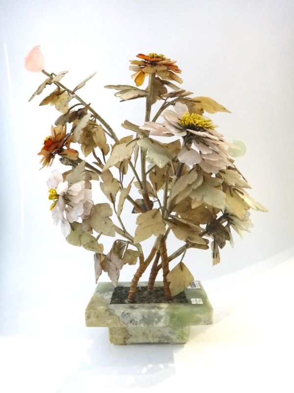 A Chinese hardstone model of a flowering tree, circa 1900, in a stepped rectangular jardinière, 47cm.high.