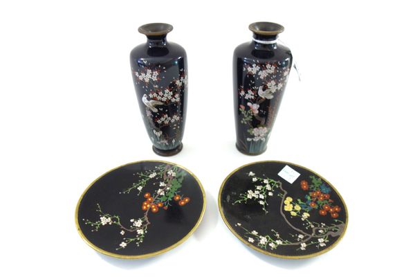 A near pair of Japanese cloisonné vases, Meiji period, of tapered cylindrical form, each worked with a bird in flowering branches against a  midnight