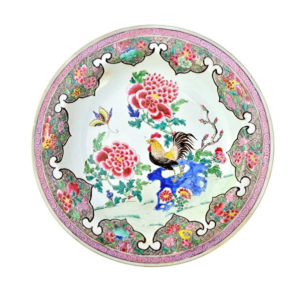 A large pair of Chinese famille-rose deep dishes, Qianlong, each painted with a cockerel perched on rockwork amongst flowering peony, a butterfly hove