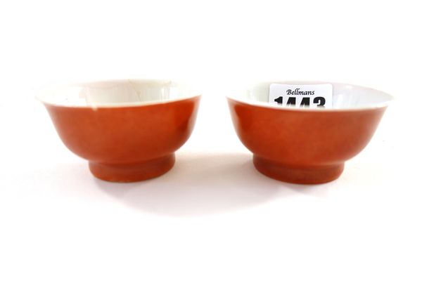 A pair of Chinese coral ground teabowls, 19th century, ( one a.f), 6.5cm.diameter,  collectors paper labels to base.