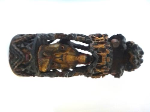 A Chinese painted and gilt carved wood group of Guanyin seated in a grotto, 19th century, the goddess seated beneath a canopy carved with four figures