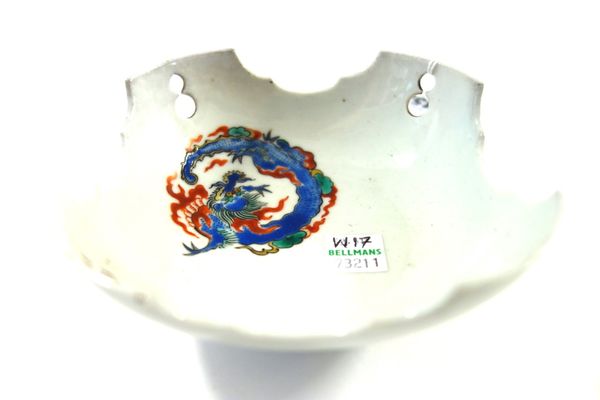 A Japanese  porcelain shaped square shallow bowl, probably 18th century, painted in a kakiemon palette with a coiled dragon, the corners pierced with