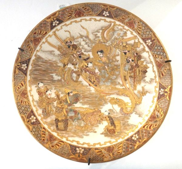 A Japanese Satsuma dish, Meiji period, painted with a deity and attendants, a samurai, children and a dragon, 34.5cm.diameter.