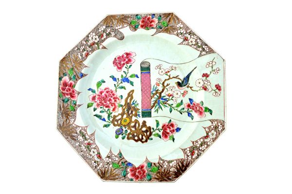 A pair of large Chinese famille-rose octagonal chargers, Qianlong, painted with a scroll painting, flowering shrubs and a pierced rock inside a brown