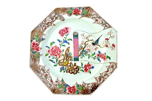 A pair of large Chinese famille-rose octagonal chargers, Qianlong, painted with a scroll painting, flowering shrubs and a pierced rock inside a brown