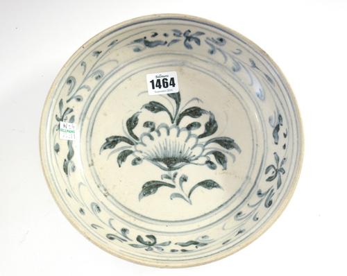A Vietnamese pottery shallow bowl, late 15th century, possibly from the Hoi an Hoard,painted in inky blue with a central flower within a trailing foli