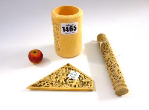 A group of four Chinese ivory carvings, late 19th/early 20th century, comprising; a cylindrical brush pot carved with two figurative panels, 9cm. high