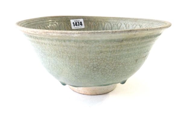 A Thai celadon glazed pottery bowl, Sawankhalok, 14th-16th century, the interior incised with overlapping stiff leaves around a central foliate medall