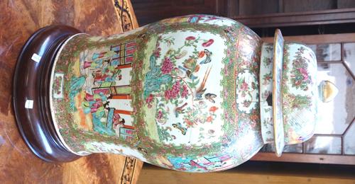A large Canton famille-rose broad baluster vase and cover, late 19th century, painted with panels of figures and panels of birds and insects amongst f