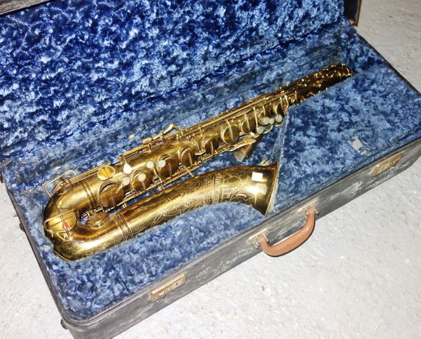 A Buescher brass saxophone, cased.
