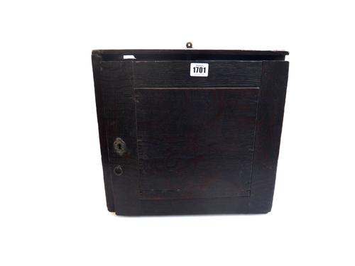 A late 16th/early 17th century oak spice cupboard with panelled door enclosing eight drawers, 36cm wide.