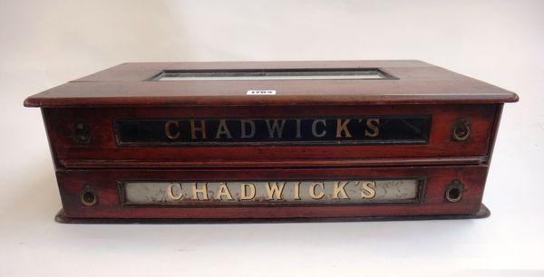 A 19th century mahogany two drawer table cabinet, both drawers with glass fronts, each with gilt lettering "Chadwick's", 54cm wide.