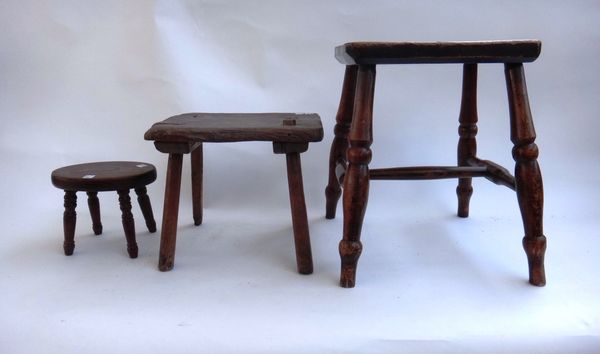 An early 19th century sycamore and ash stool on turned supports, 36cm wide, together with a primitive ash and elm stool on stake supports, 31cm wide,