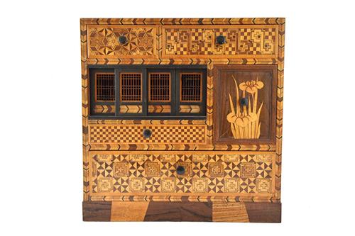 A Japanese parquetry inlaid specimen wood table top Tansu cabinet, with an arrangement of drawers and sliding cupboards, on a plinth base, 36cm wide,