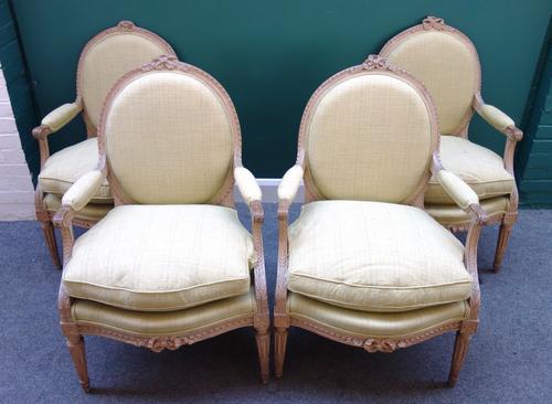 A set of four Louis XVI style open armchairs, each with padded oval back and serpentine seats, on tapering fluted supports, one stamped 'G. Jacob'. (4