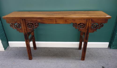 A 20th century Chinese hardwood altar table, with pierced and carved frieze, on moulded square section supports, 173cm wide.