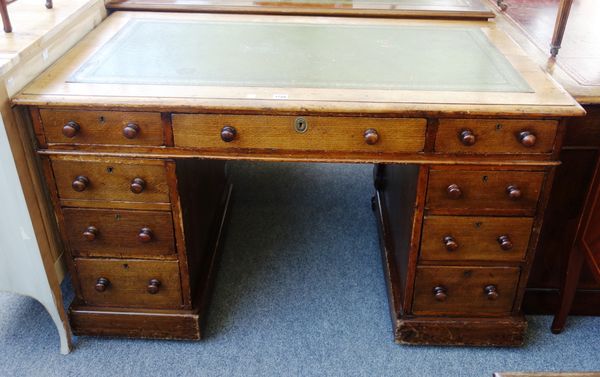 A Victorian oak pedestal desk with nine drawers about the knee, 121cm wide.