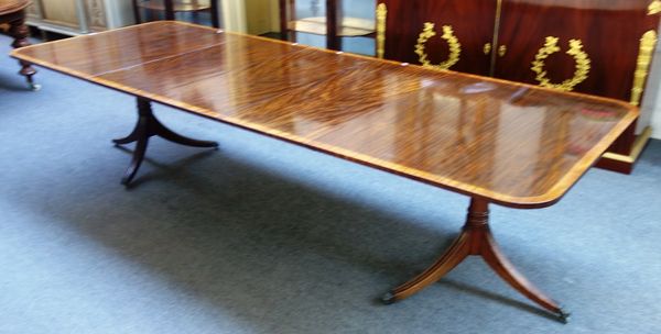 A George III style mahogany twin pedestal 'D' end extending dining table, on six downswept supports, with three extra leaves, 112cm wide x 165cm long