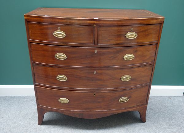 An early 19th century mahogany and inlaid bowfront chest of two short and three long graduated drawers, on splayed bracket feet, 107cm wide.