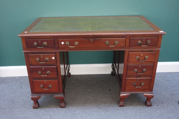 An 18th century style mahogany pedestal desk with nine drawers about the knee, on claw and ball feet, 122cm wide.