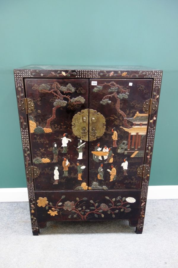 A Chinese black lacquer hardstone and ivory mounted two door side cupboard, circa 1890, depicting figures in a landscape, on block feet, 88cm wide.