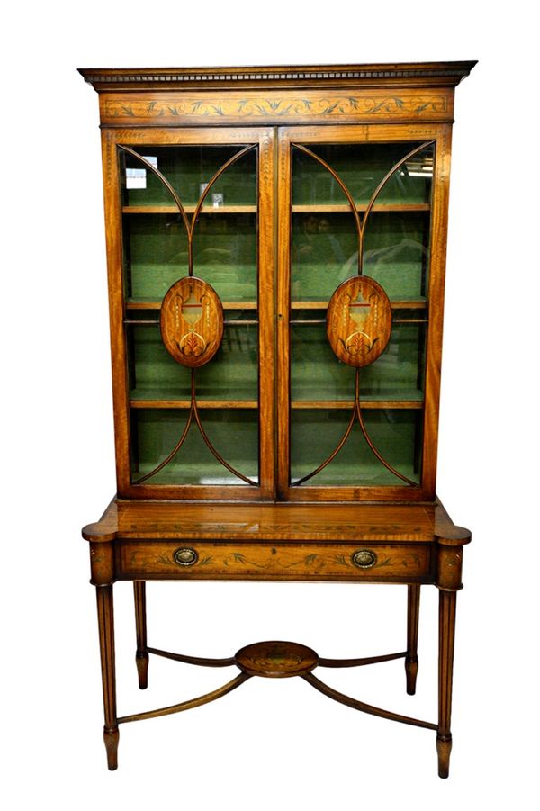 A pair of 20th century painted satinwood display cabinets on stands, each with pair of upper glazed doors over one long drawer, on outstepped fluted s