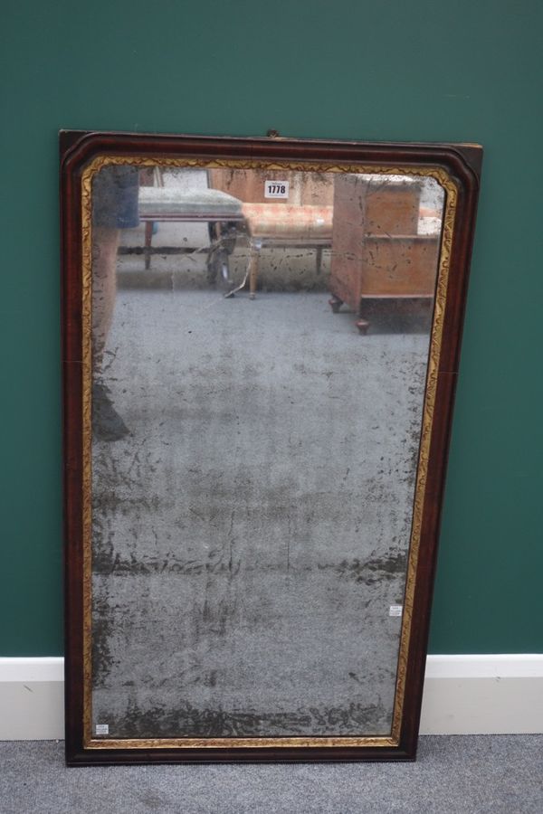 A George II parcel gilt walnut framed rectangular wall mirror, with rounded arch top, 55cm wide x 95cm high.