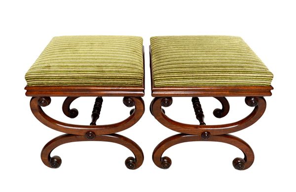 A pair of William IV mahogany framed square top footstools, on 'X' frame supports, united by turned stretcher, 43cm wide, (2). Illustrated