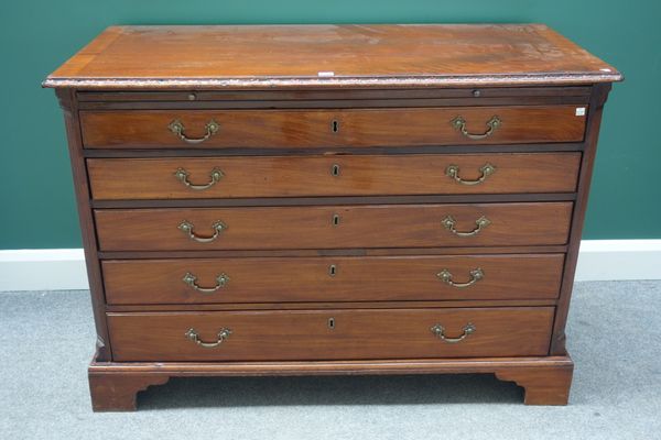 A late 18th century German mahogany commode, the brushing slide over five long graduated drawers flanked by fluted canted supports, on bracket feet, 1