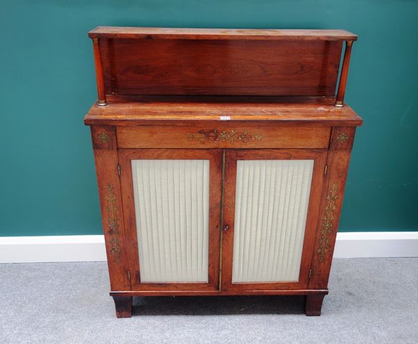 A Regency brass inlaid rosewood chiffonier, with ledge back over pair of pleated doors, on sabre supports, 92cm wide.