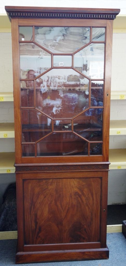 A George III mahogany bookcase cabinet, the single astragal glazed door over panelled cupboard, on plinth base, 86cm wide x 209cm high.