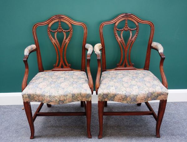 A pair of late 19th century Hepplewhite design mahogany framed carver chairs, each with serpentine seat on splayed square supports, (2).