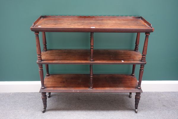 An early 19th century mahogany three tier étagère, on turned supports, 102cm wide.