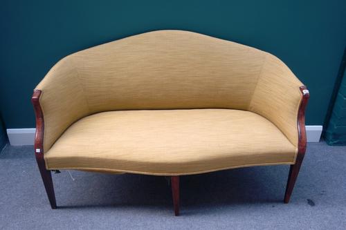A George III mahogany framed tub back sofa with serpentine seat on tapering square supports, 150cm wide.