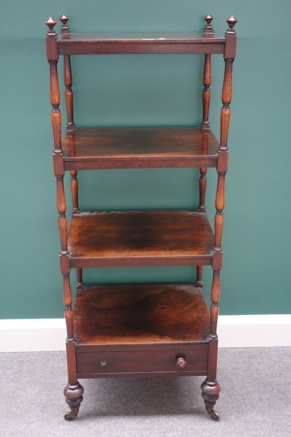 A Victorian rosewood four tier whatnot, on turned supports, the lower platform with single drawer, 49cm wide.