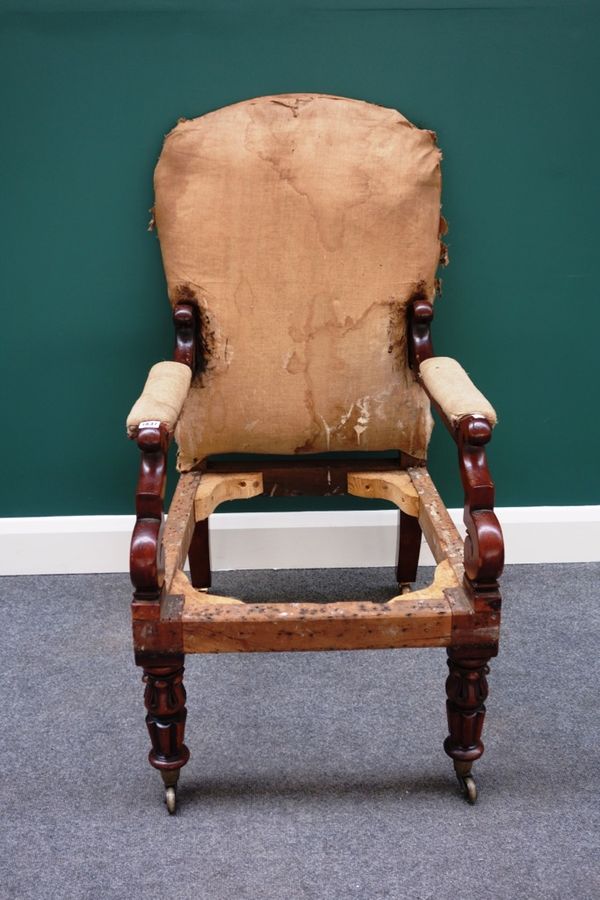 A William IV mahogany framed open armchair, with semi-padded arms and straight front seat, on lappet and reeded supports.