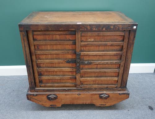 A late 19th/early 20th century Japanese Tansu on four integral wheels, 98cm wide.